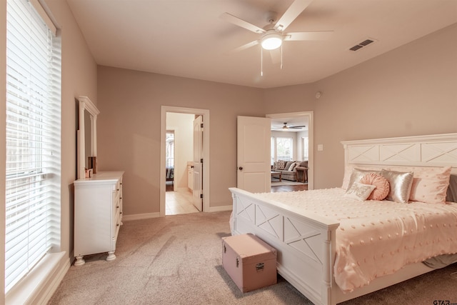 bedroom with light carpet and ceiling fan