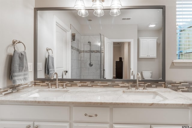 bathroom featuring walk in shower, vanity, and toilet