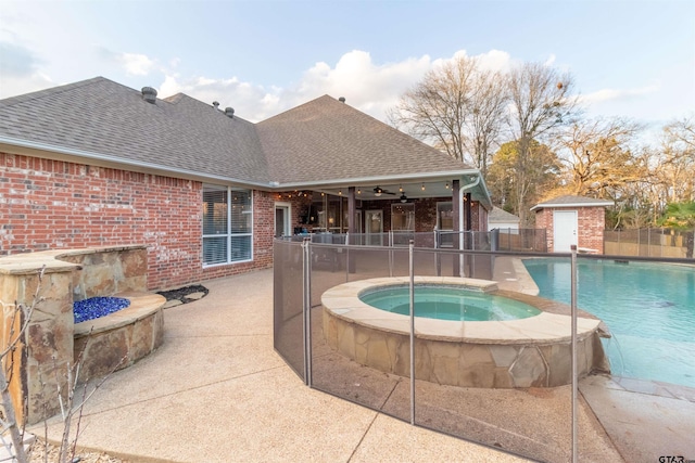 view of swimming pool with an in ground hot tub, pool water feature, and a patio