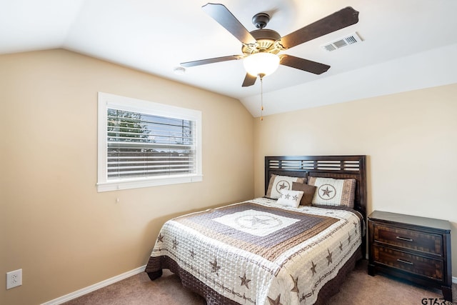 carpeted bedroom with ceiling fan and vaulted ceiling