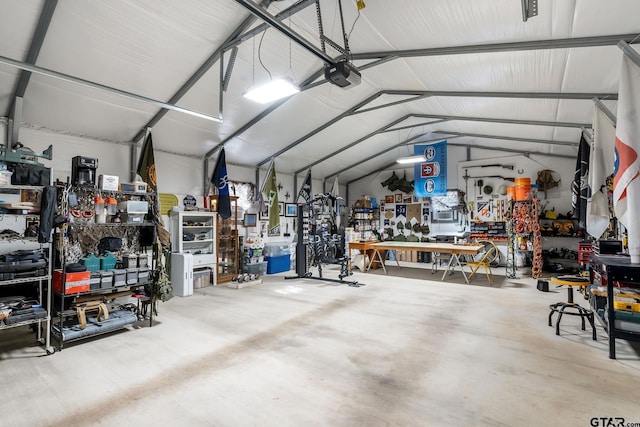 garage with a garage door opener and a workshop area