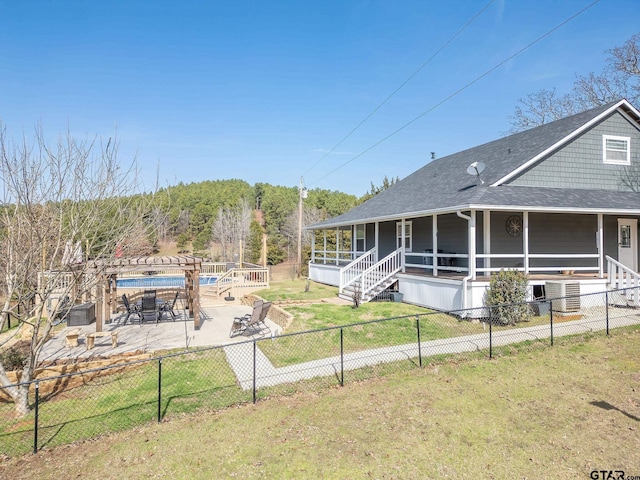 view of front of house with a pergola, a front lawn, and central air condition unit