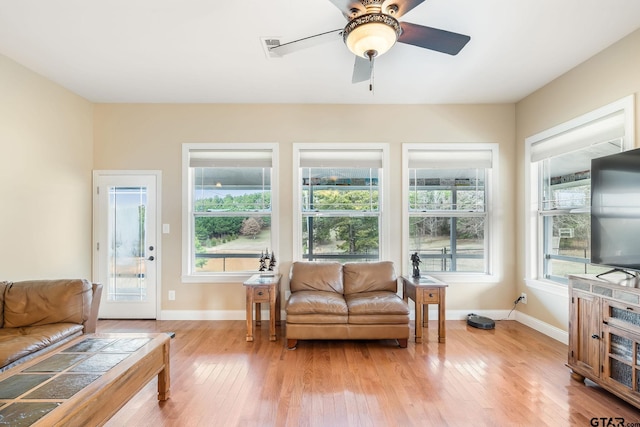 interior space with ceiling fan and light hardwood / wood-style flooring