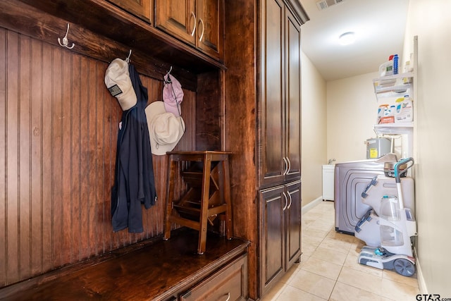 mudroom with light tile patterned flooring and washer / dryer