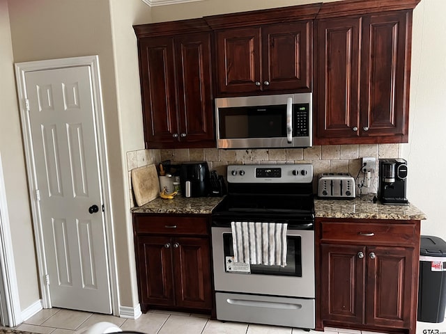 112 Letha Ct, Tyler, TX 75702 - kitchen with stainless steel appliances, tasteful backsplash, stone countertops, light tile patterned floors, and dark brown cabinets