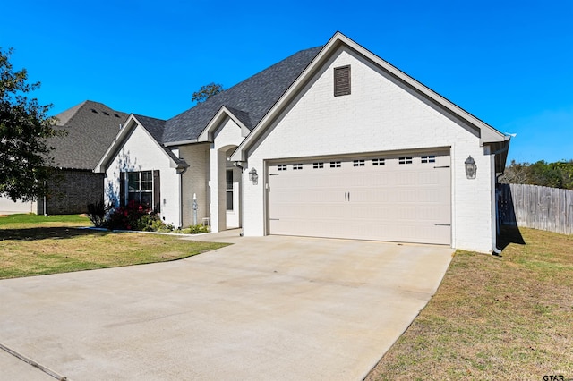 view of front of house featuring a front lawn and a garage