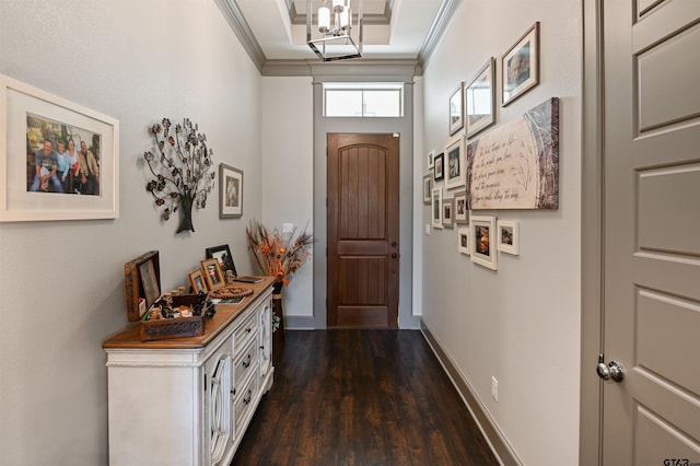 entryway with a notable chandelier, ornamental molding, and dark wood-type flooring