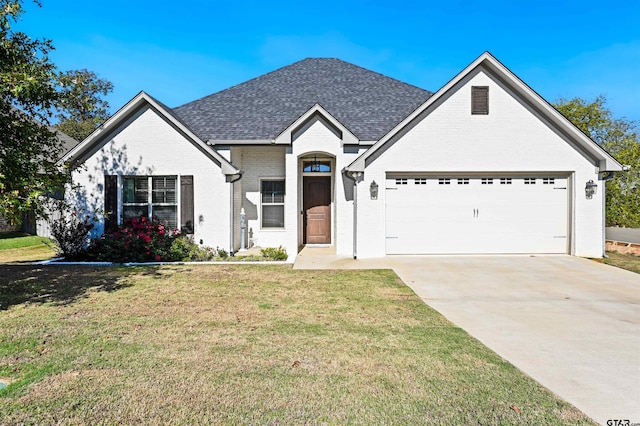 view of front of house with a garage and a front lawn