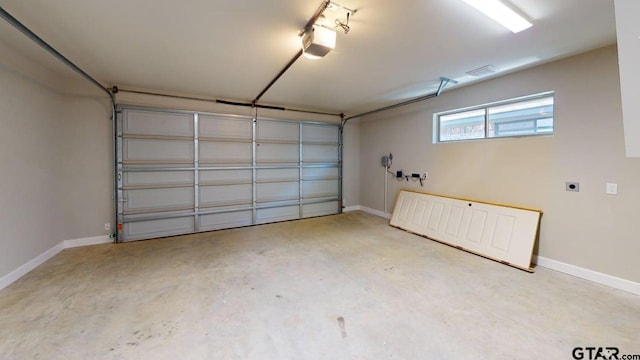 19346 Aida Dr, Flint, TX 75762 - garage with a garage door opener and baseboards