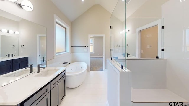19346 Aida Dr, Flint, TX 75762 - full bath featuring a stall shower, a soaking tub, two vanities, lofted ceiling, and tile patterned flooring