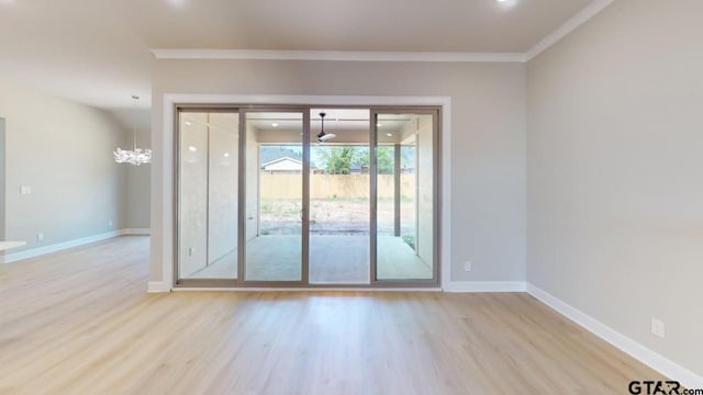 19346 Aida Dr, Flint, TX 75762 - unfurnished room with wood finished floors, ornamental molding, and a chandelier