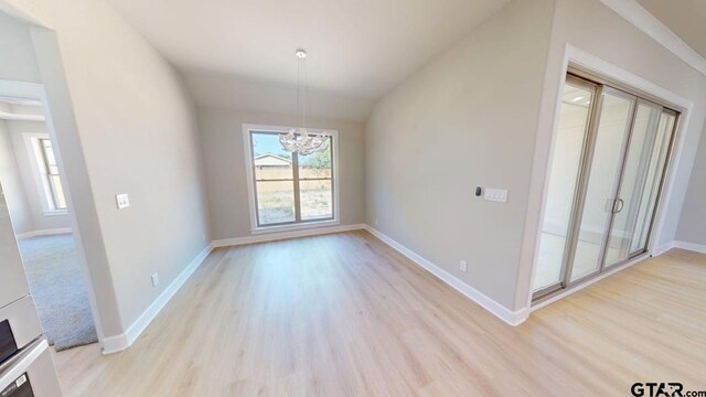 19346 Aida Dr, Flint, TX 75762 - unfurnished dining area featuring a chandelier, light wood-style floors, and vaulted ceiling