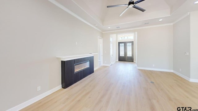 19346 Aida Dr, Flint, TX 75762 - unfurnished living room with light wood-type flooring, a glass covered fireplace, recessed lighting, a ceiling fan, and french doors