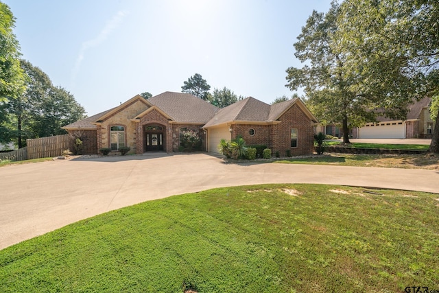 view of front of property with a front yard and a garage