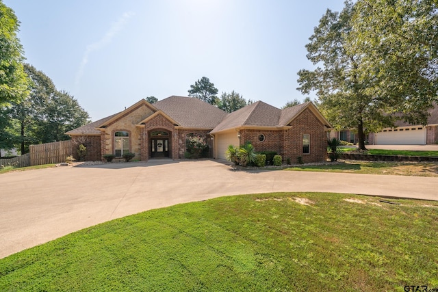 view of front of home featuring a front yard and a garage