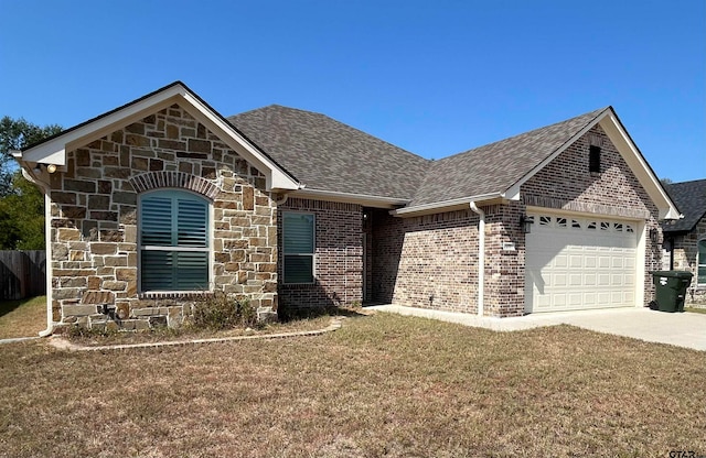 view of front of home featuring a garage and a front yard