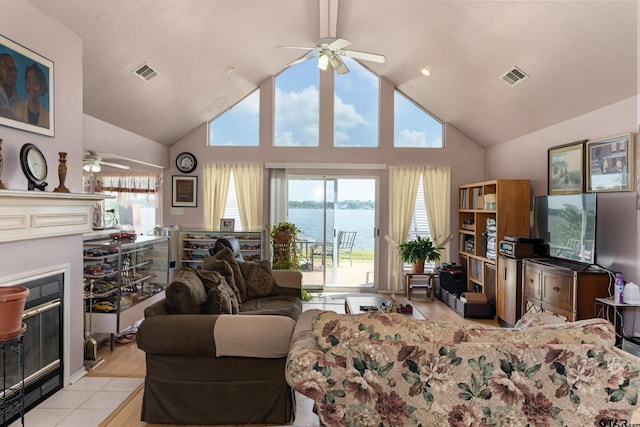 15541 Precidio Cir, Malakoff, TX 75148 - living room featuring a ceiling fan, a fireplace with flush hearth, and high vaulted ceiling