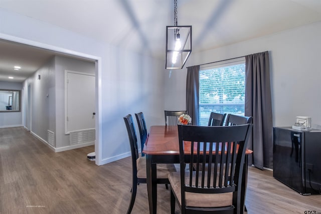 dining space with hardwood / wood-style floors