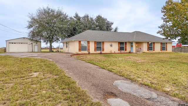 ranch-style house with an outbuilding, a front lawn, and a garage