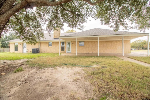 back of property featuring a lawn and central AC unit