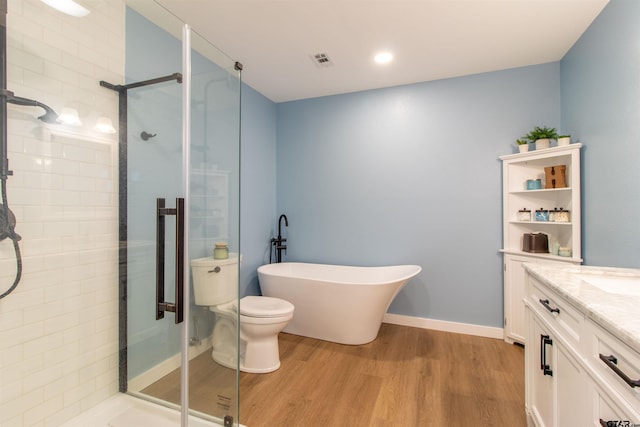 full bathroom featuring vanity, toilet, wood-type flooring, and shower with separate bathtub