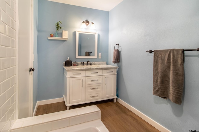 bathroom with hardwood / wood-style floors and vanity