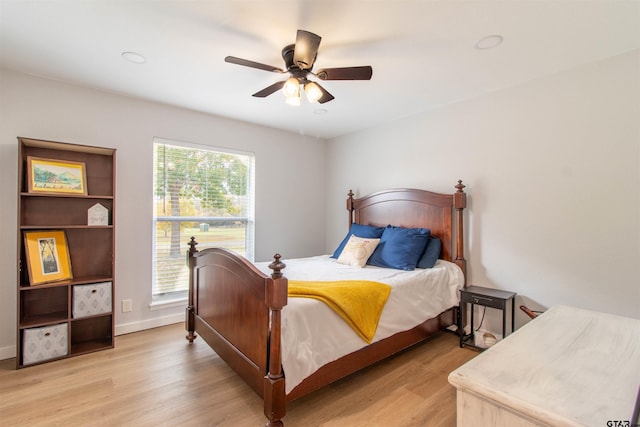 bedroom with ceiling fan and light hardwood / wood-style flooring