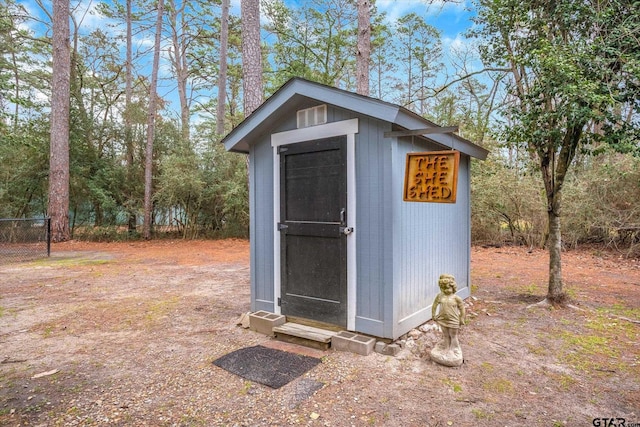 view of shed with fence