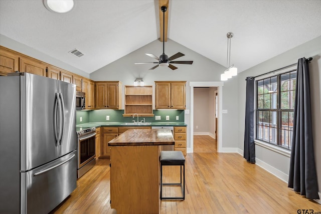 kitchen with light wood finished floors, open shelves, visible vents, appliances with stainless steel finishes, and a kitchen island