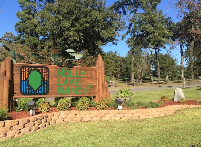 community / neighborhood sign with a lawn