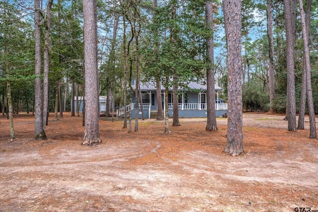 view of front of property with covered porch and metal roof