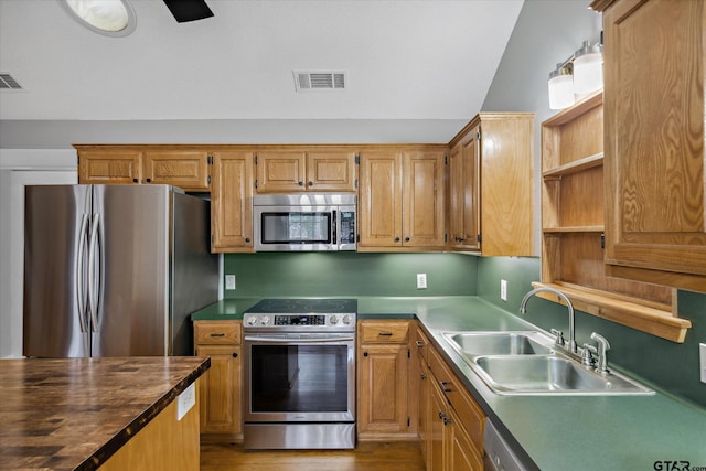 kitchen with open shelves, visible vents, appliances with stainless steel finishes, vaulted ceiling, and a sink