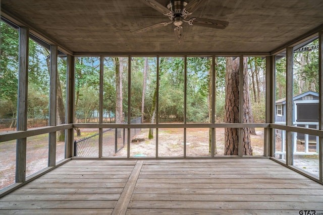 unfurnished sunroom with a wealth of natural light and a ceiling fan