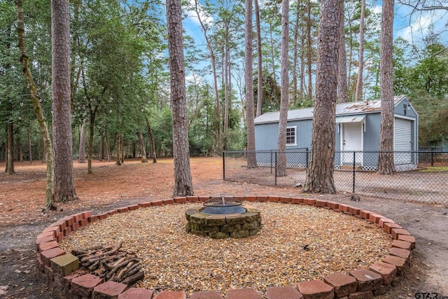 view of yard with a fire pit and fence