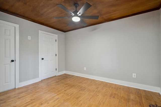 unfurnished room with wood ceiling, light wood-style flooring, baseboards, and ceiling fan