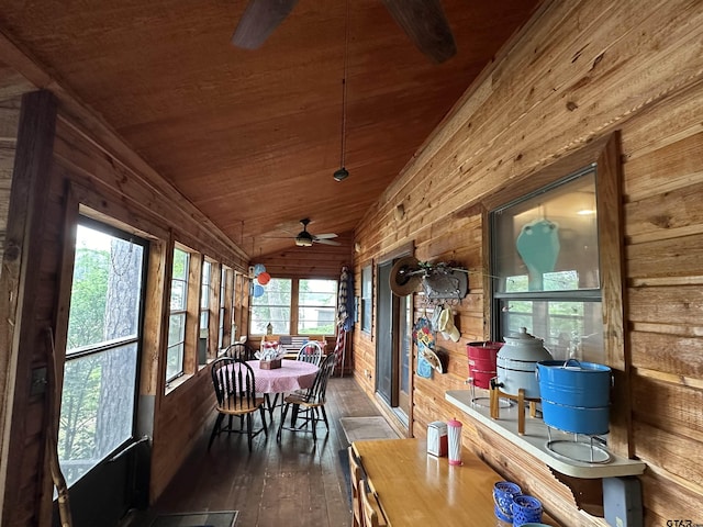 sunroom with lofted ceiling, ceiling fan, and wooden ceiling