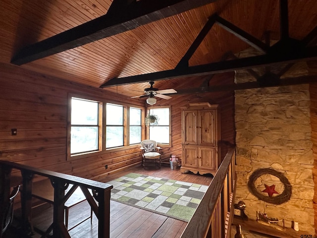 interior space with beam ceiling, ceiling fan, and wood ceiling