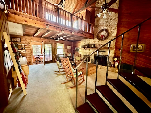 stairs featuring beam ceiling, high vaulted ceiling, a wealth of natural light, and ceiling fan