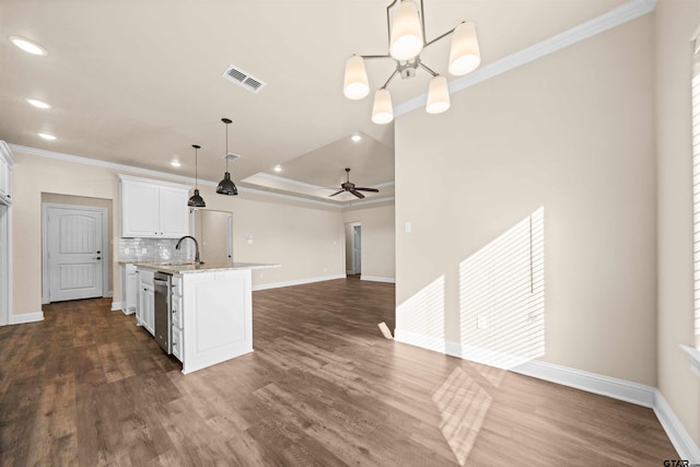 kitchen with crown molding, dark wood-type flooring, white cabinetry, hanging light fixtures, and an island with sink