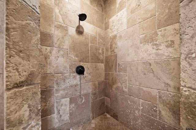 interior details with a tile shower