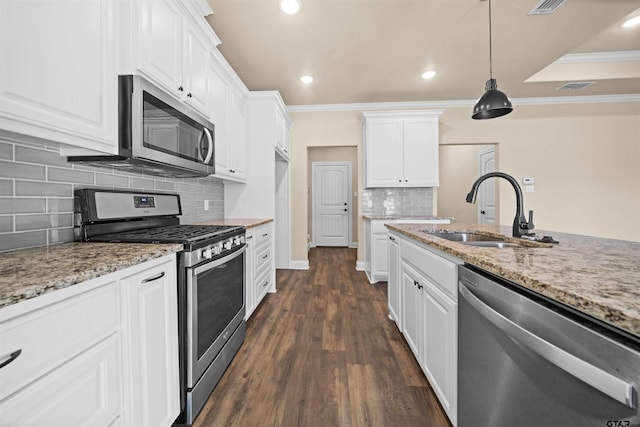 kitchen featuring appliances with stainless steel finishes, white cabinetry, dark wood-type flooring, and sink