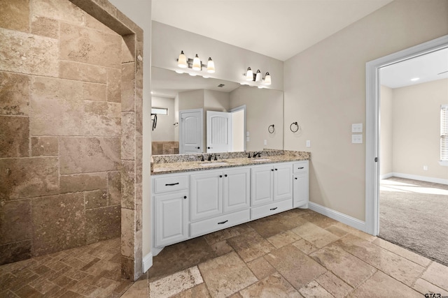 bathroom featuring vanity and tiled shower