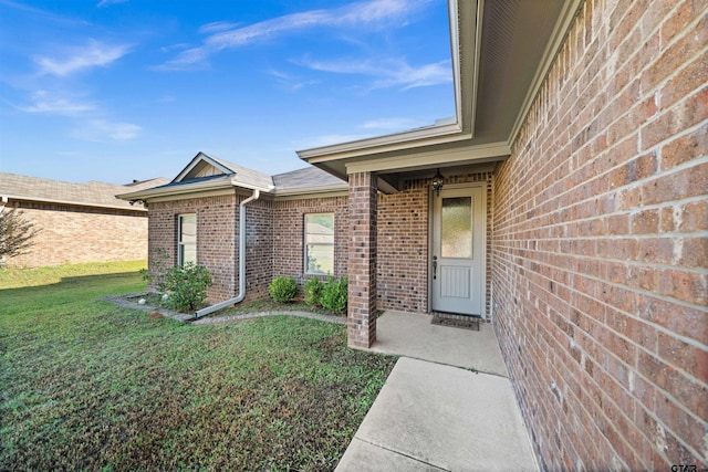 doorway to property featuring a yard