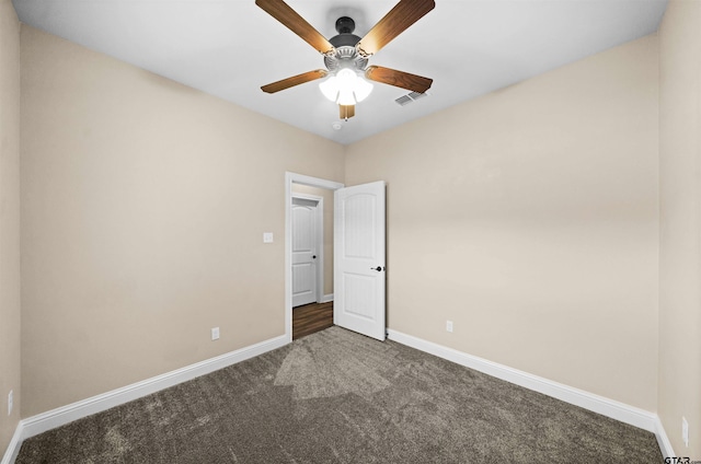 unfurnished bedroom featuring dark carpet and ceiling fan