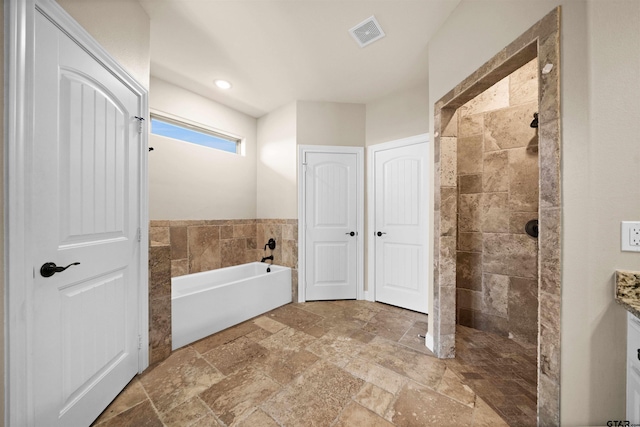 bathroom with shower with separate bathtub