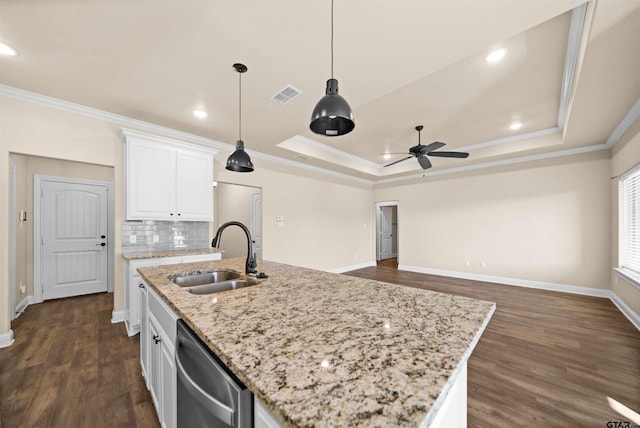 kitchen with white cabinetry, stainless steel dishwasher, a kitchen island with sink, and sink