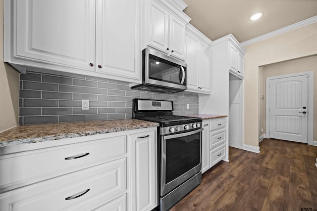 kitchen with white cabinetry, dark wood-type flooring, stainless steel appliances, and light stone counters