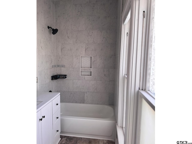 bathroom featuring vanity and tiled shower / bath combo