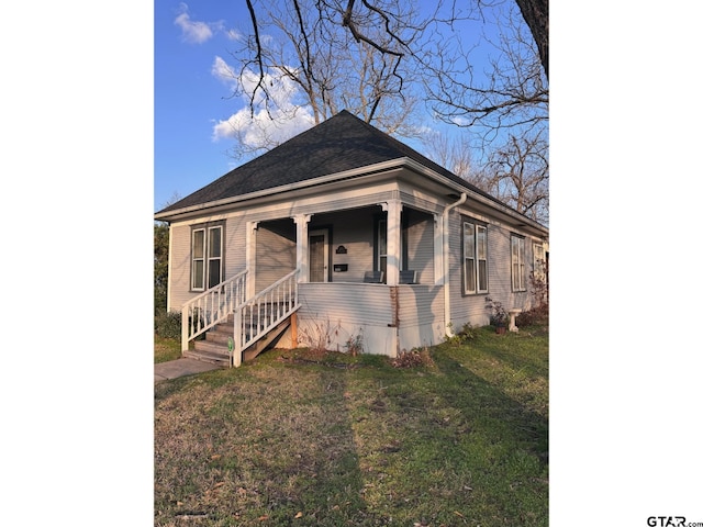 bungalow-style house with covered porch and a front lawn