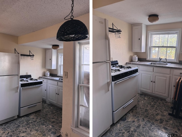 kitchen with white appliances, sink, hanging light fixtures, and a textured ceiling